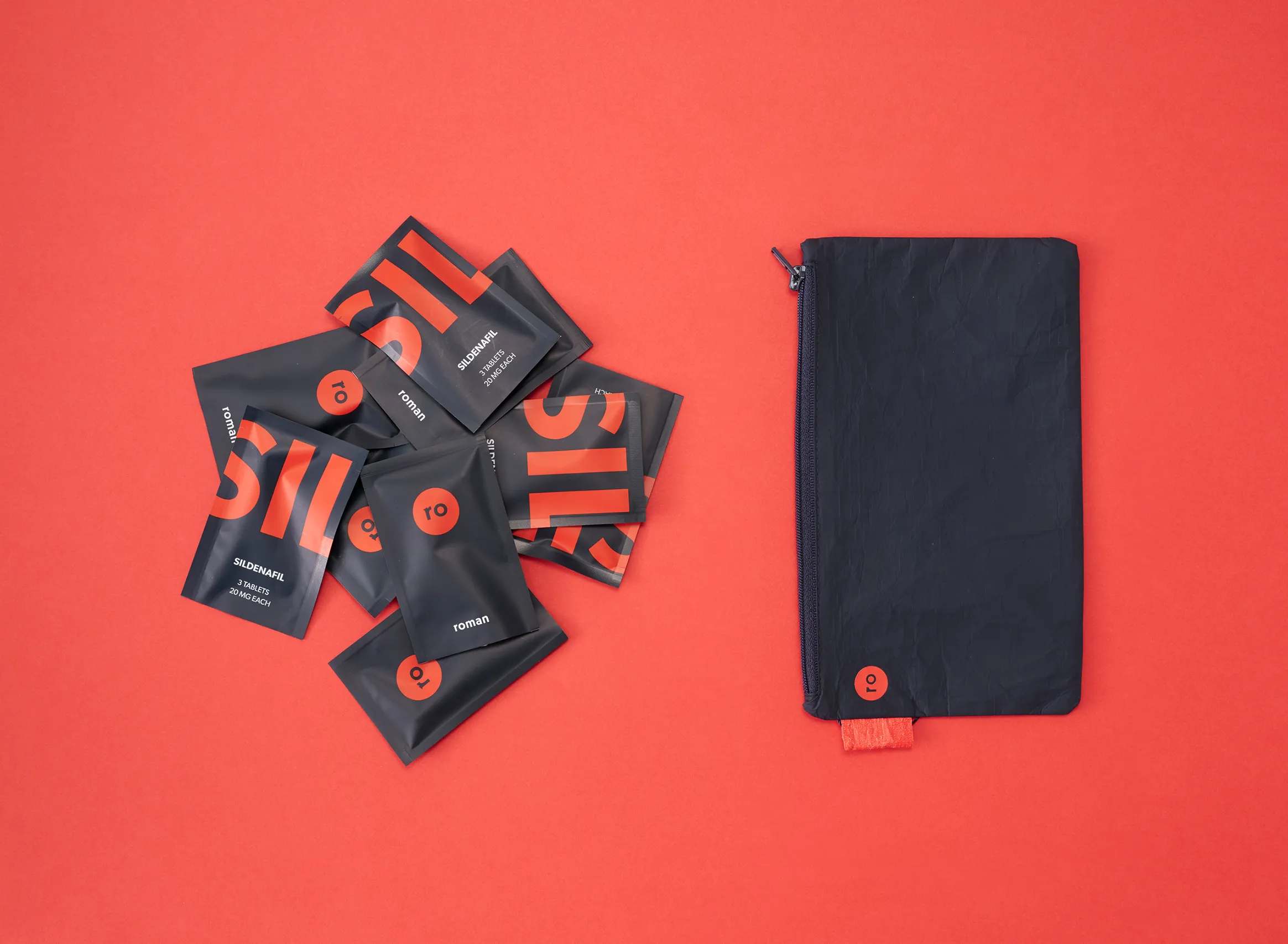 Black Ro medication pouches and reusable zippered bag on a red background