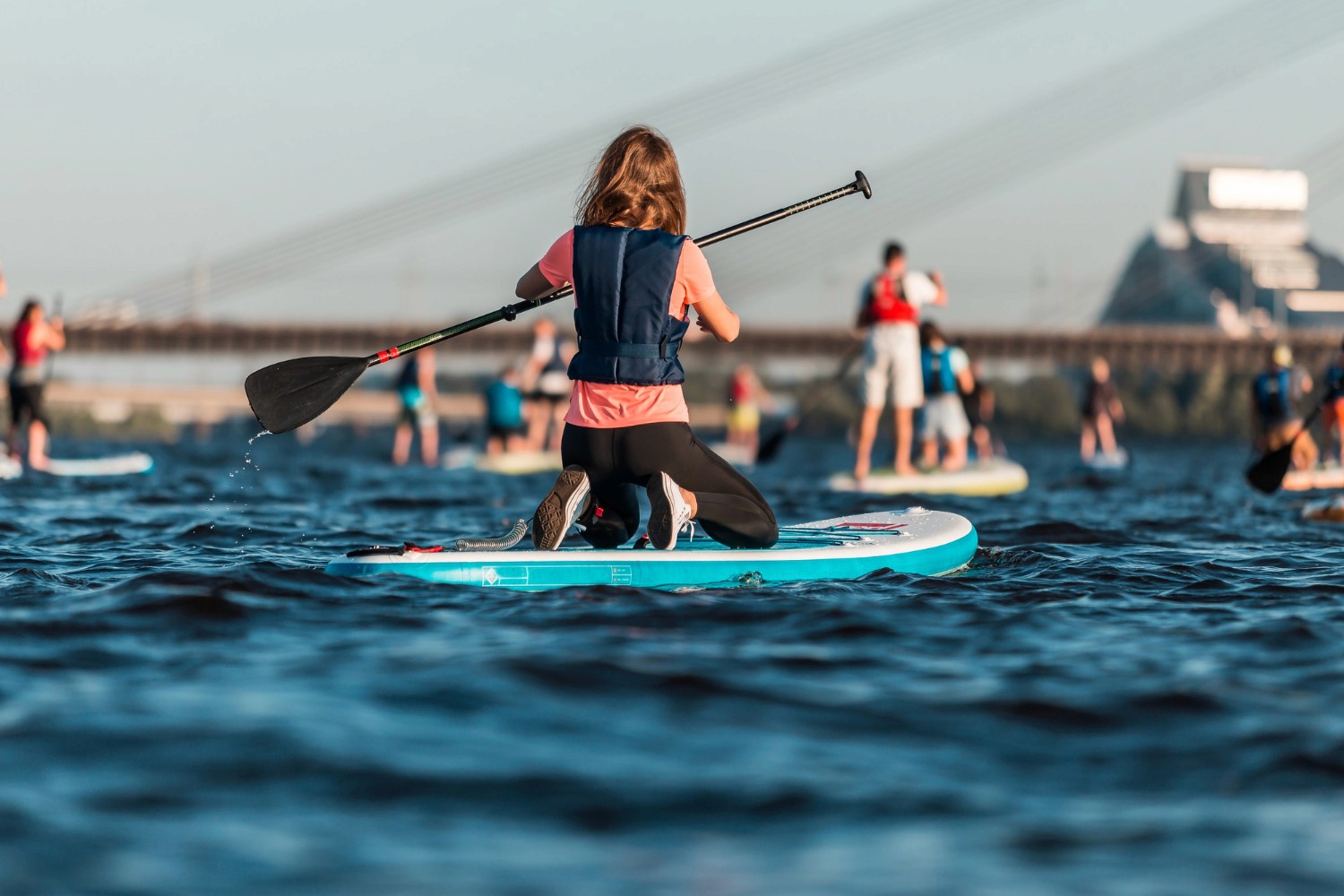 man in black and red jacket wearing gray cap riding on white and orange kayak on on on on on