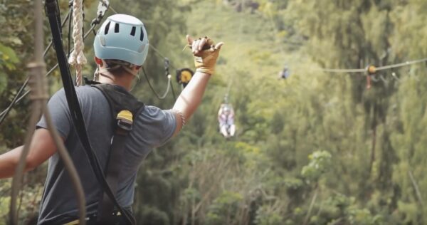 A Climbworks guide throwing the shaka hand symbol in Oahu