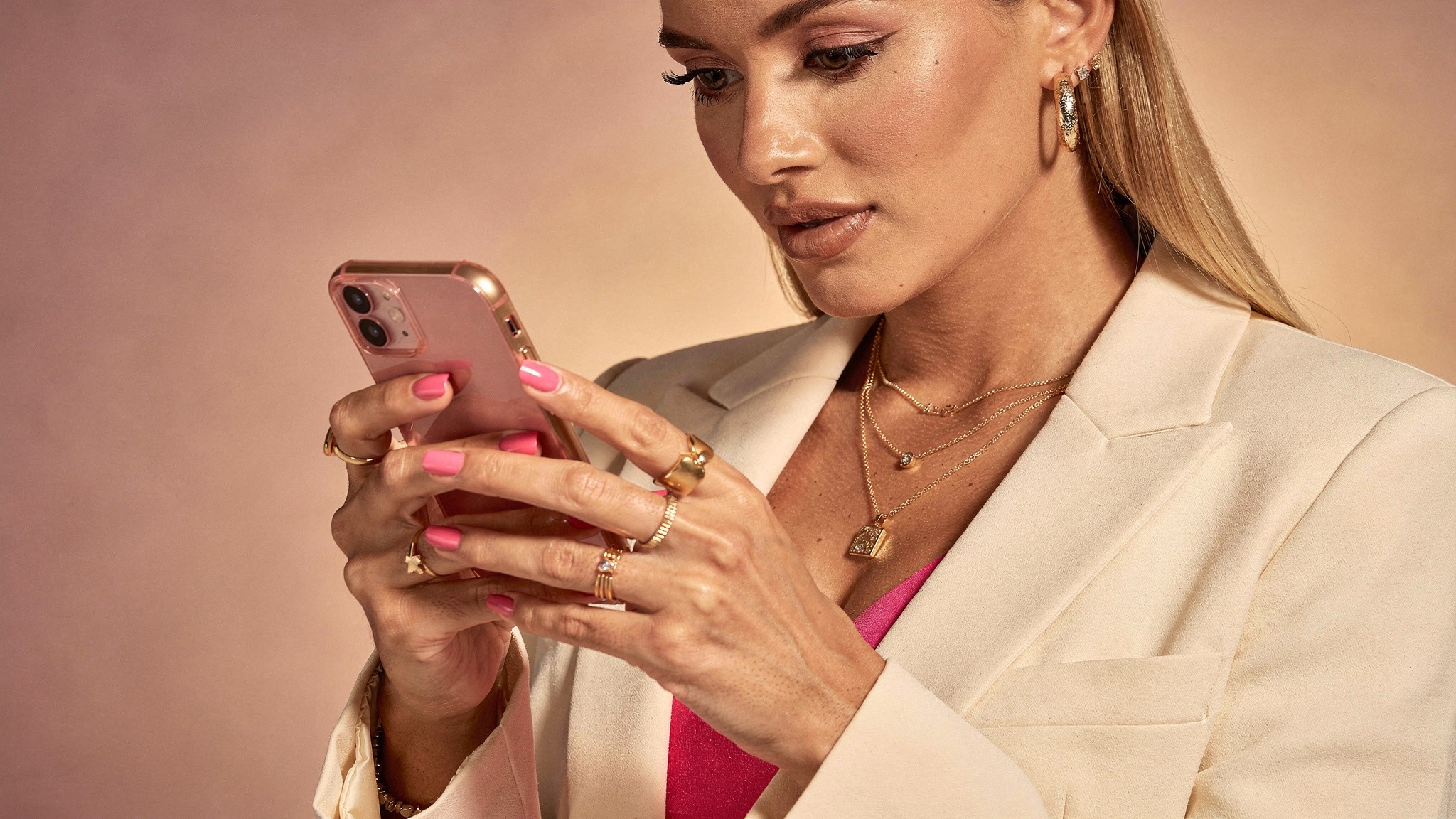 Creator typing an Instagram caption on her phone with hashtags placed directly in the caption text