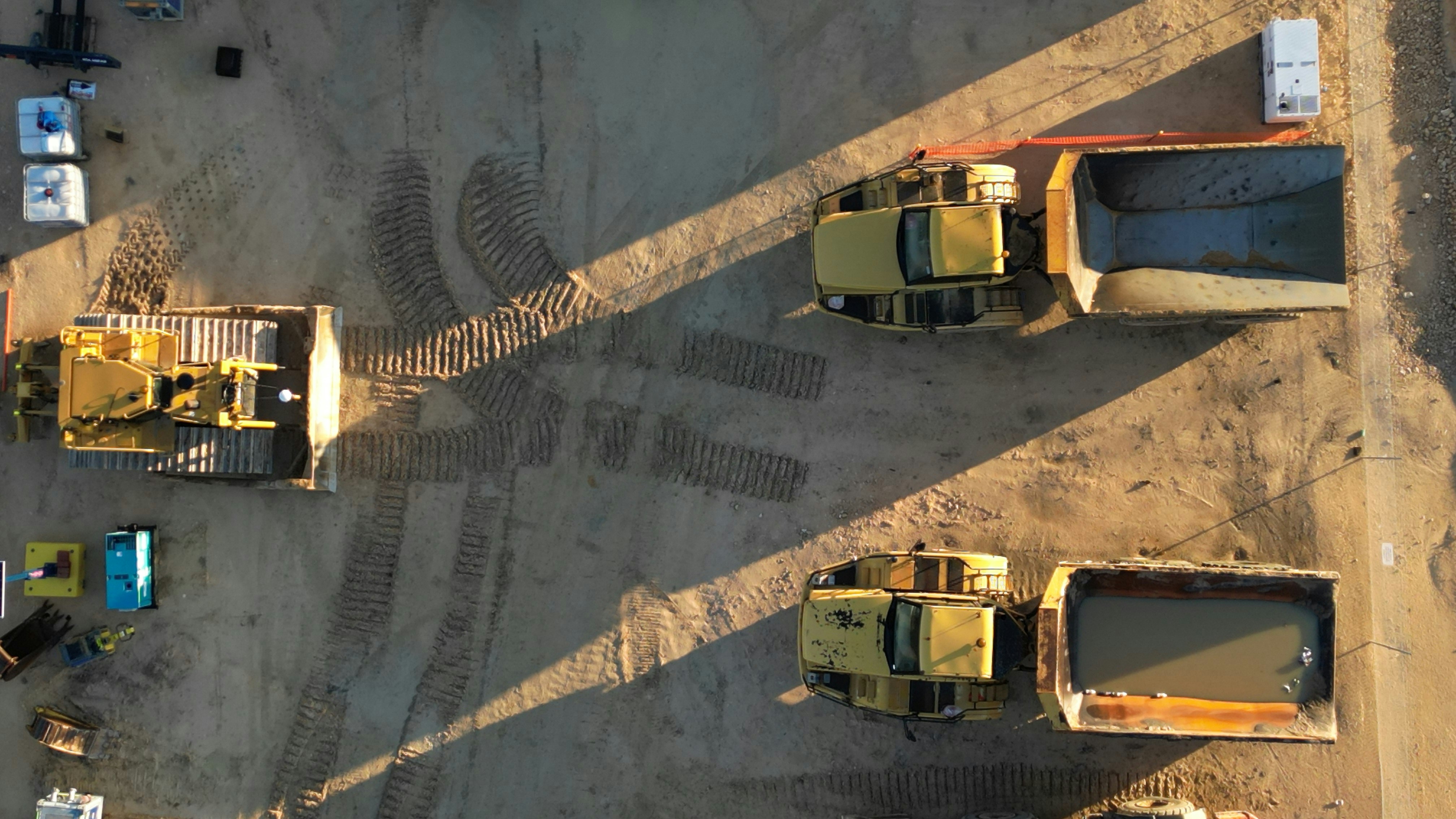 A group of dump trucks parked next to each other