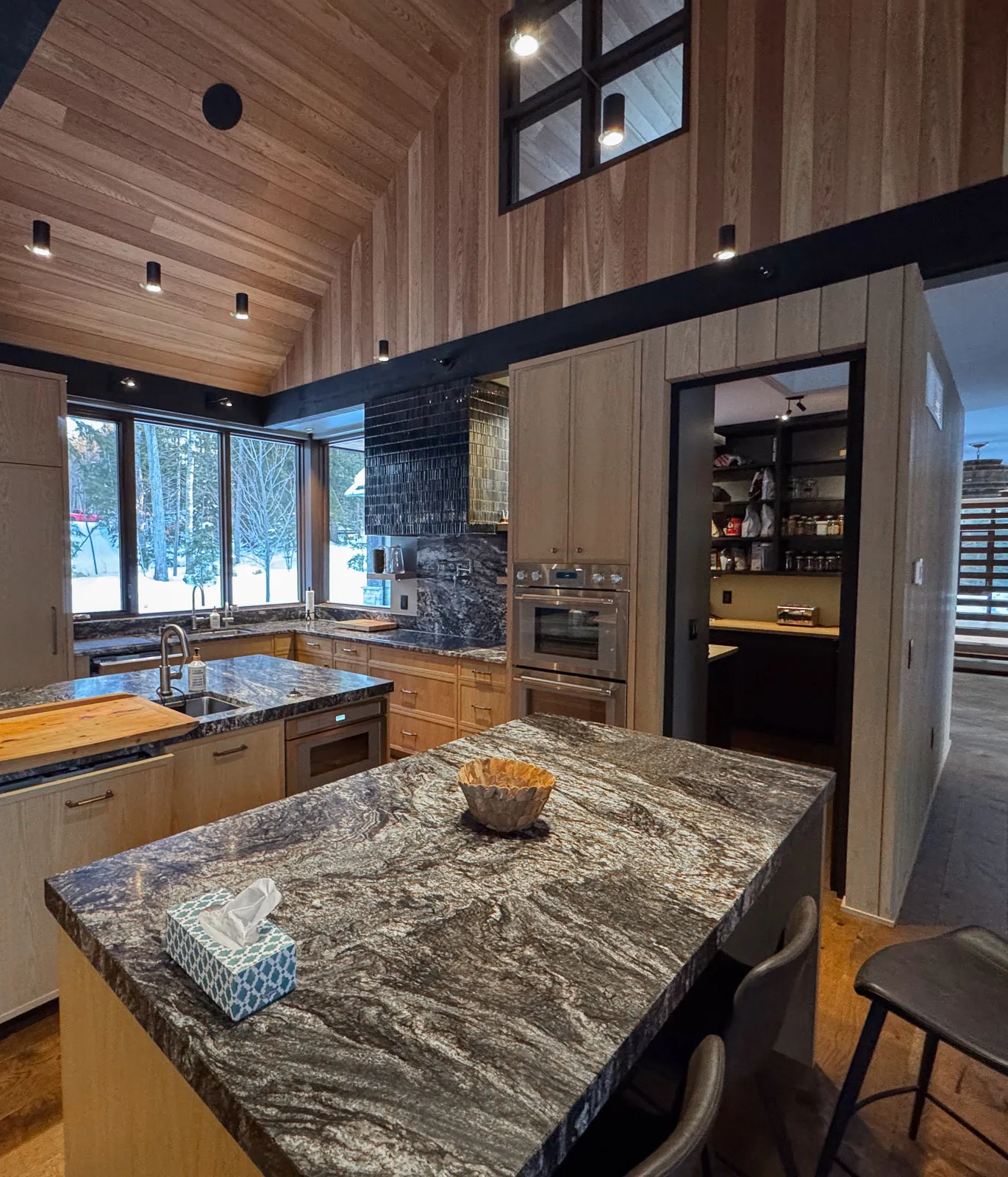 custom granite countertops and walk-in pantry in luxury lakefront propterty.