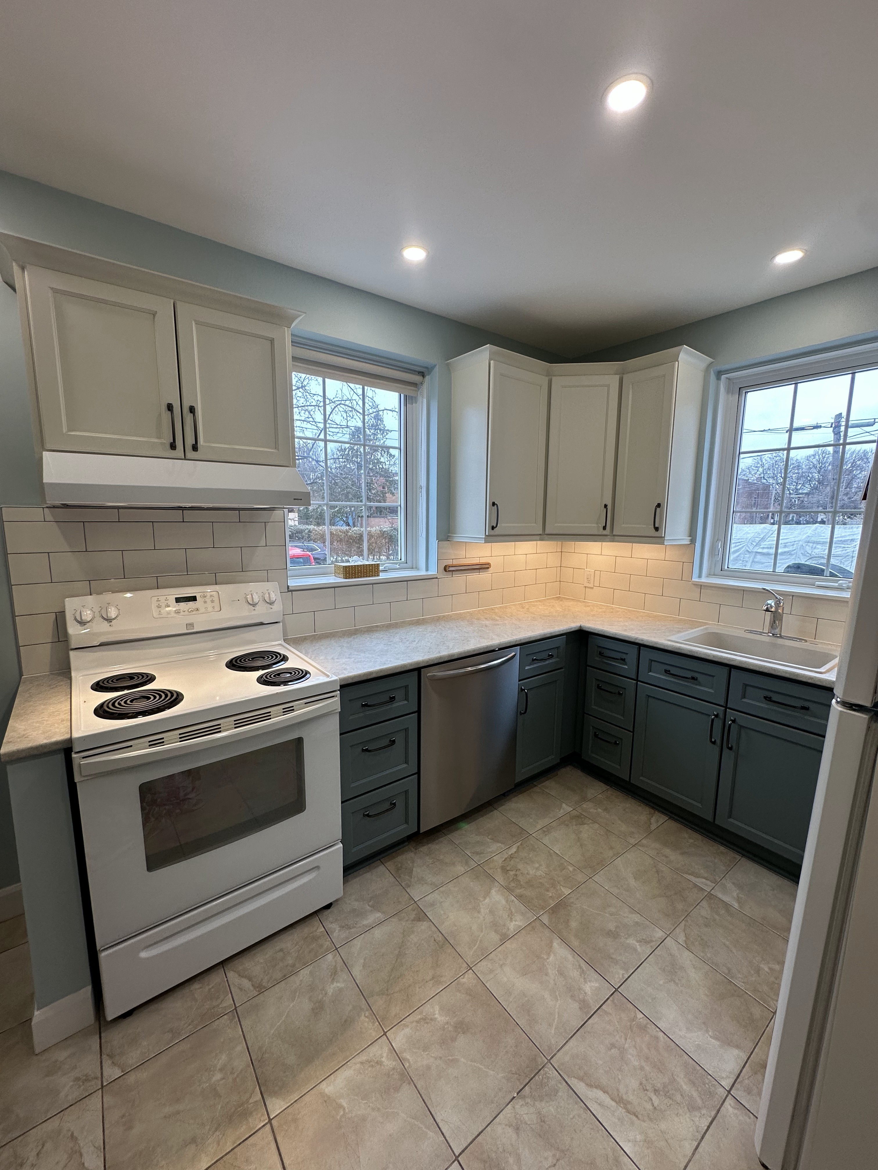 Finished NDG kitchen with new countertops and subway tile backsplash