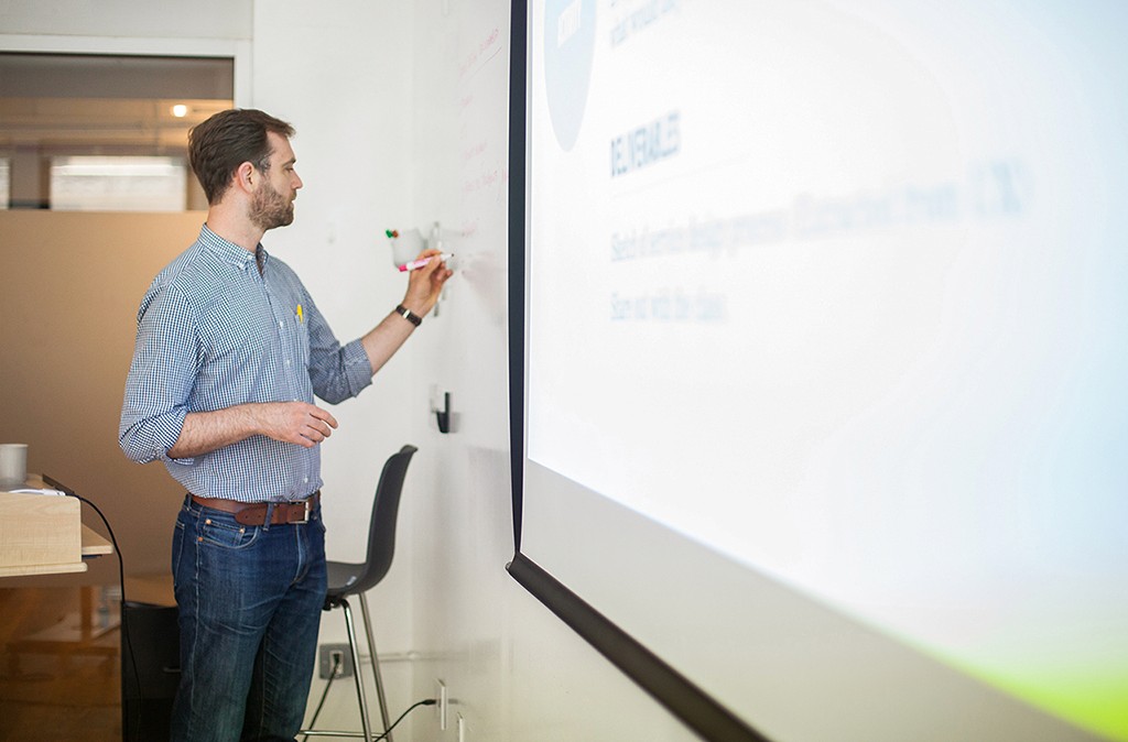 A learner in a final review session, presenting work with clarity and conviction.