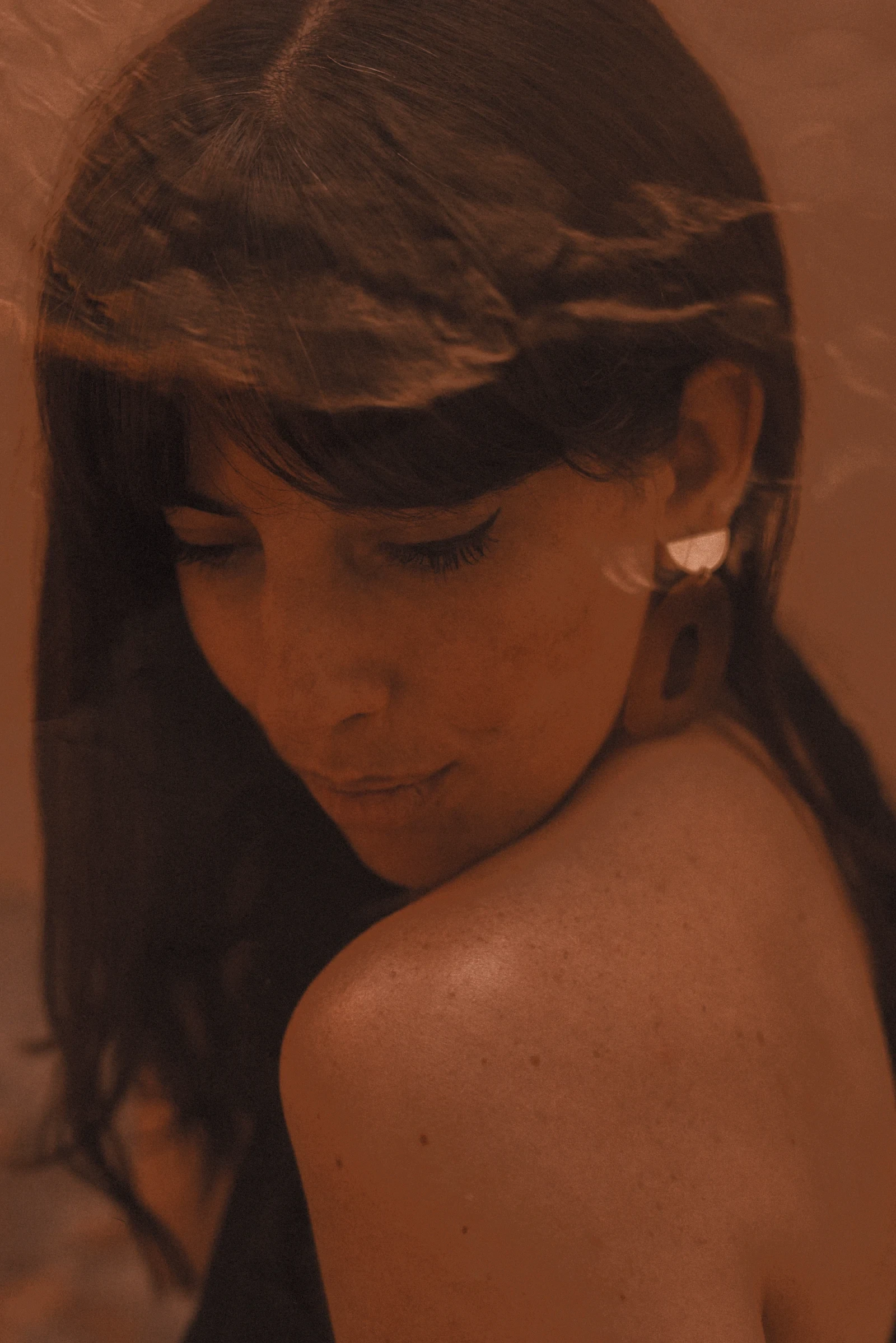 A woman wearing a gold earring