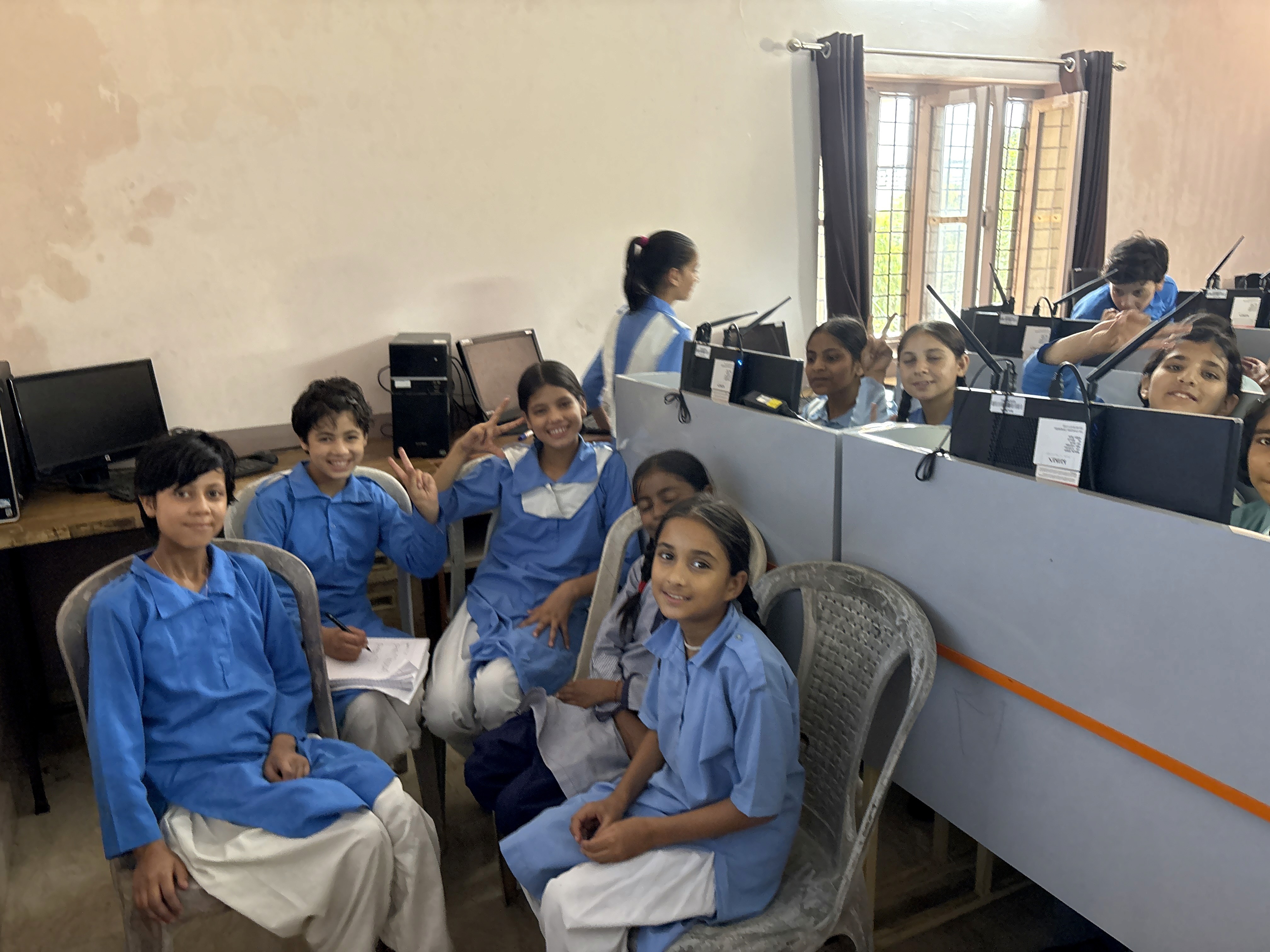 two people in a workspace working on their laptops 