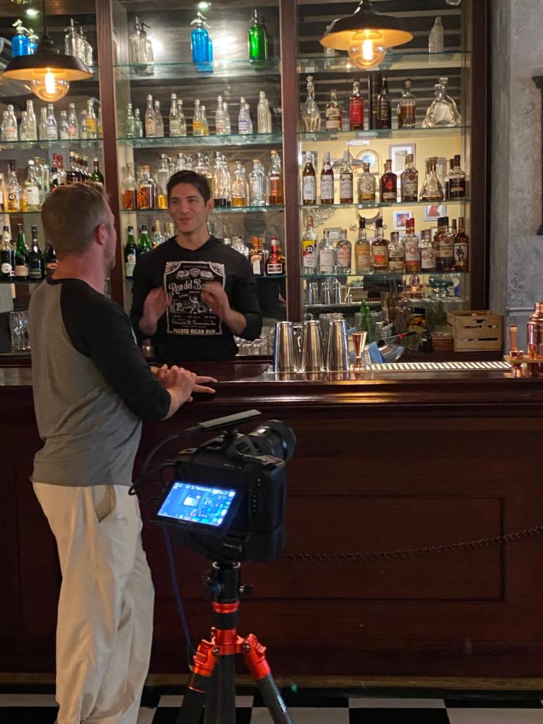 Film crew interviewing a bartender at a Puerto Rico rum bar during documentary production