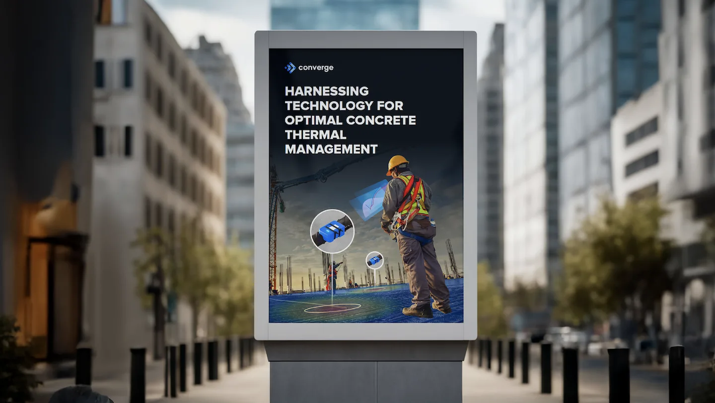 Converge advertising on a city digital billboard showing a construction worker and thermal monitoring technology messaging.