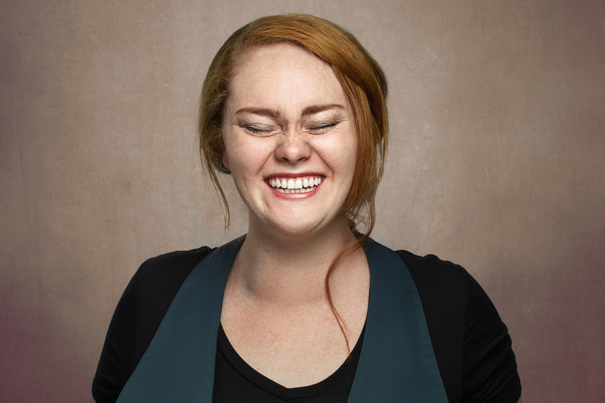 Approachable executive headshot of a Black male leader with dreadlocks, signaling warmth and creativity. Modern business portrait photography Oakland.