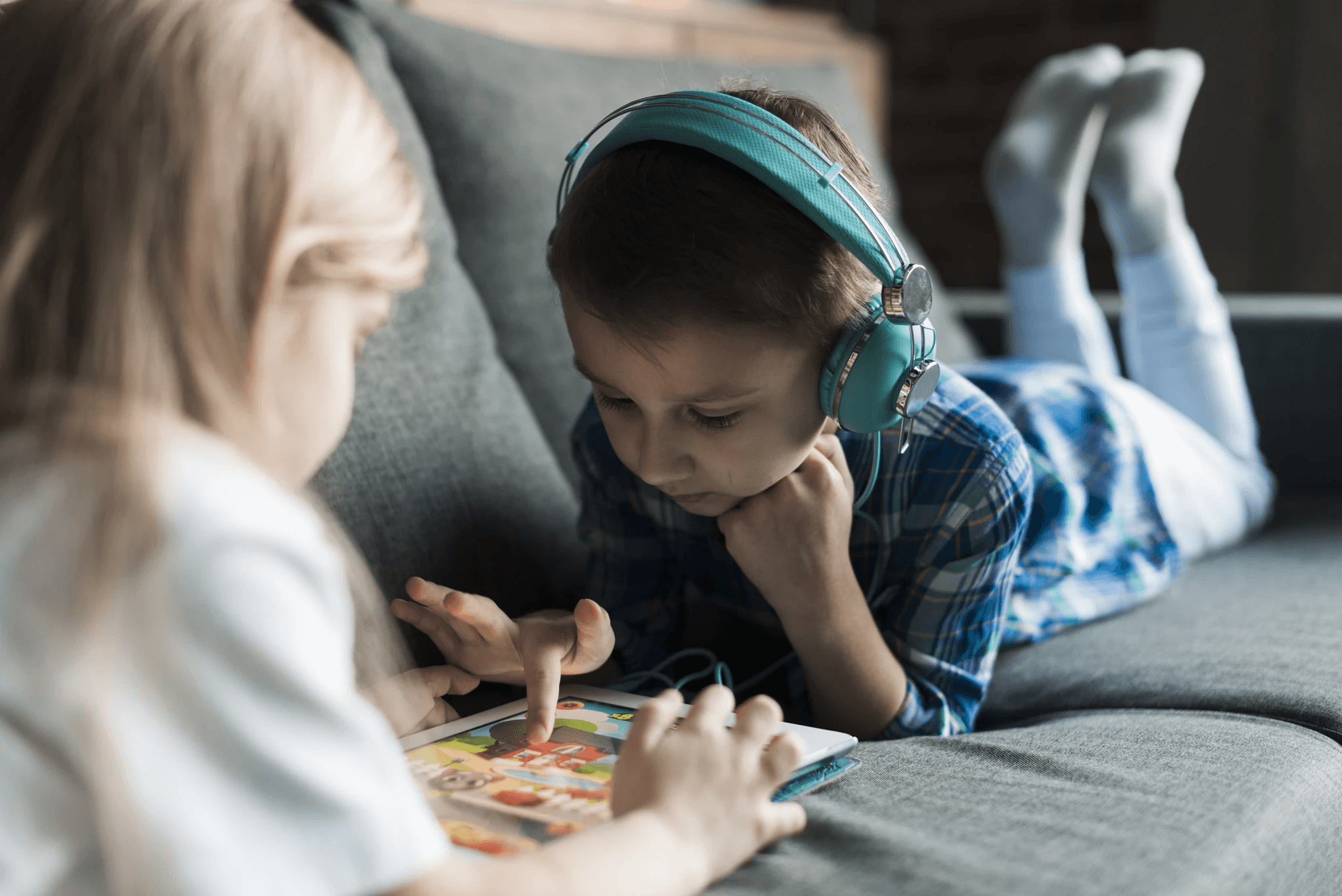 Young child using headphones during an autism assessment session in a calm, supportive environment