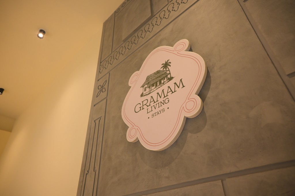 A person lying on a massage table, their face covered with a towel, bathed in warm golden light. The setting exudes relaxation and comfort.