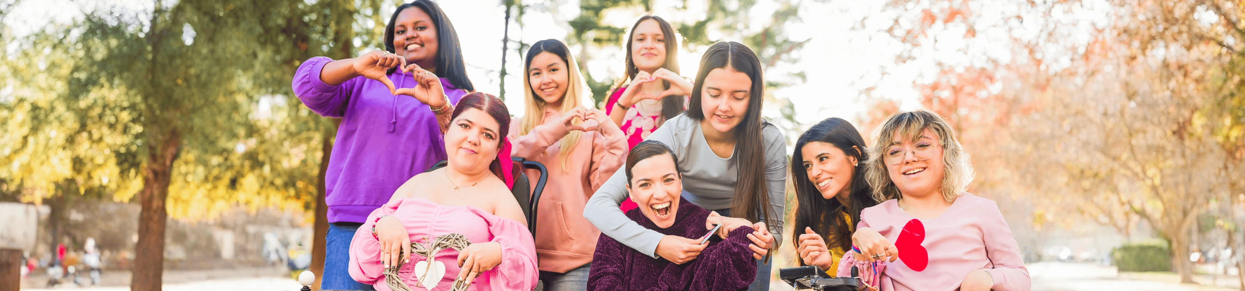 Young people with coloured dust on their faces lying on the grass enjoying each other's company