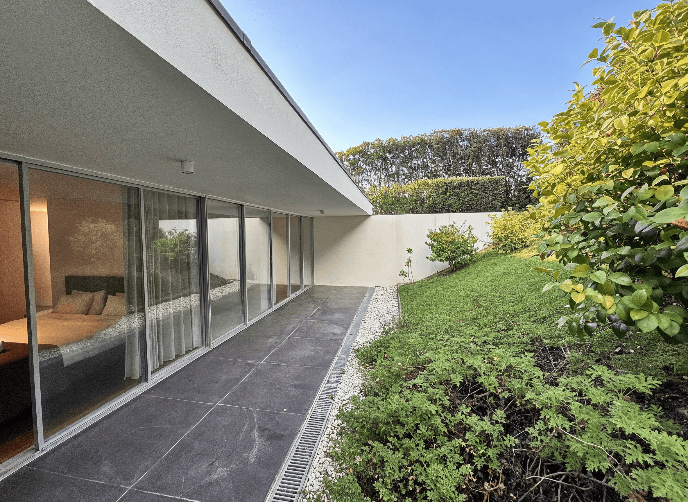 Wooden bench overlooking forested hills and a lake