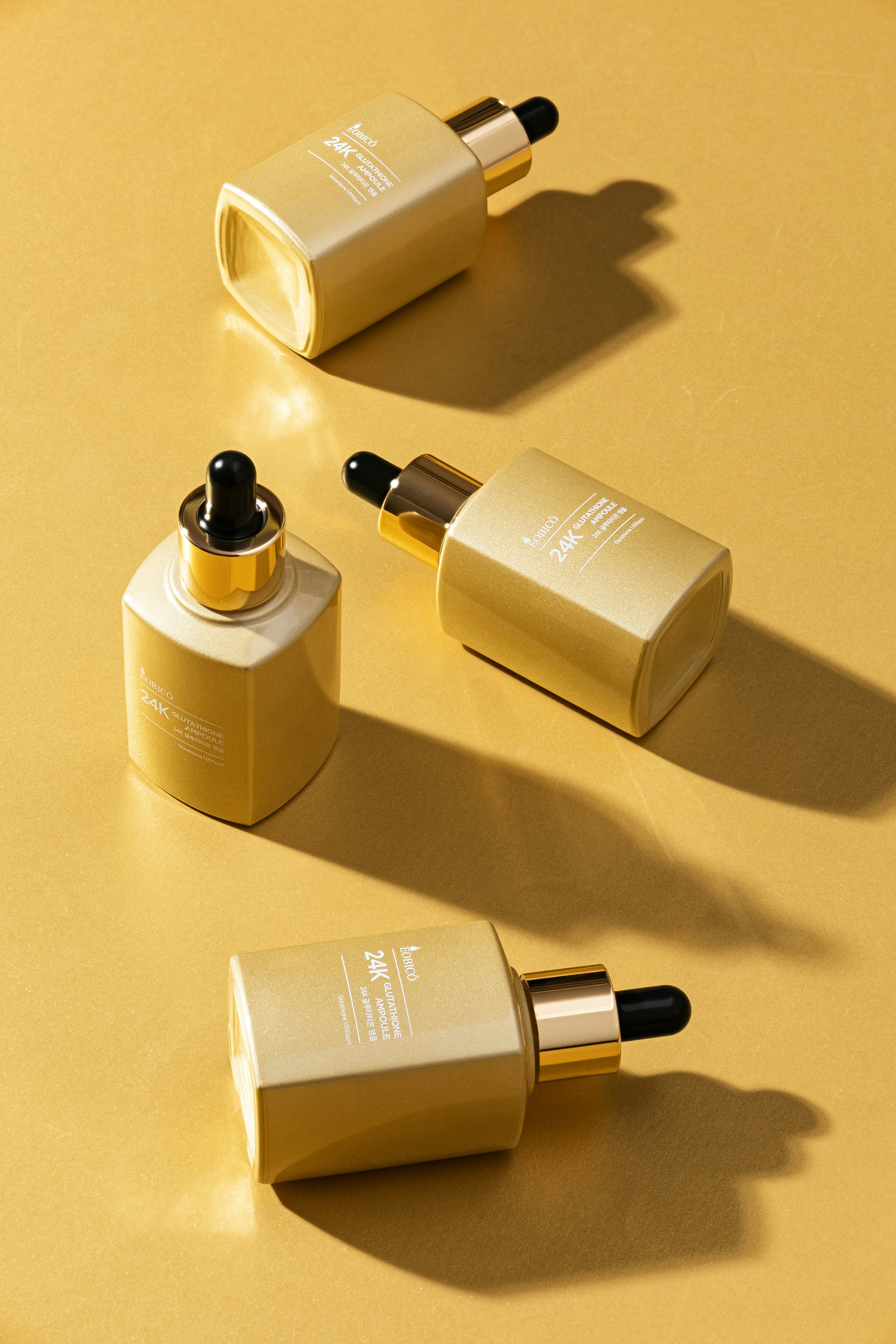 three bottles of lipstick sitting on a table