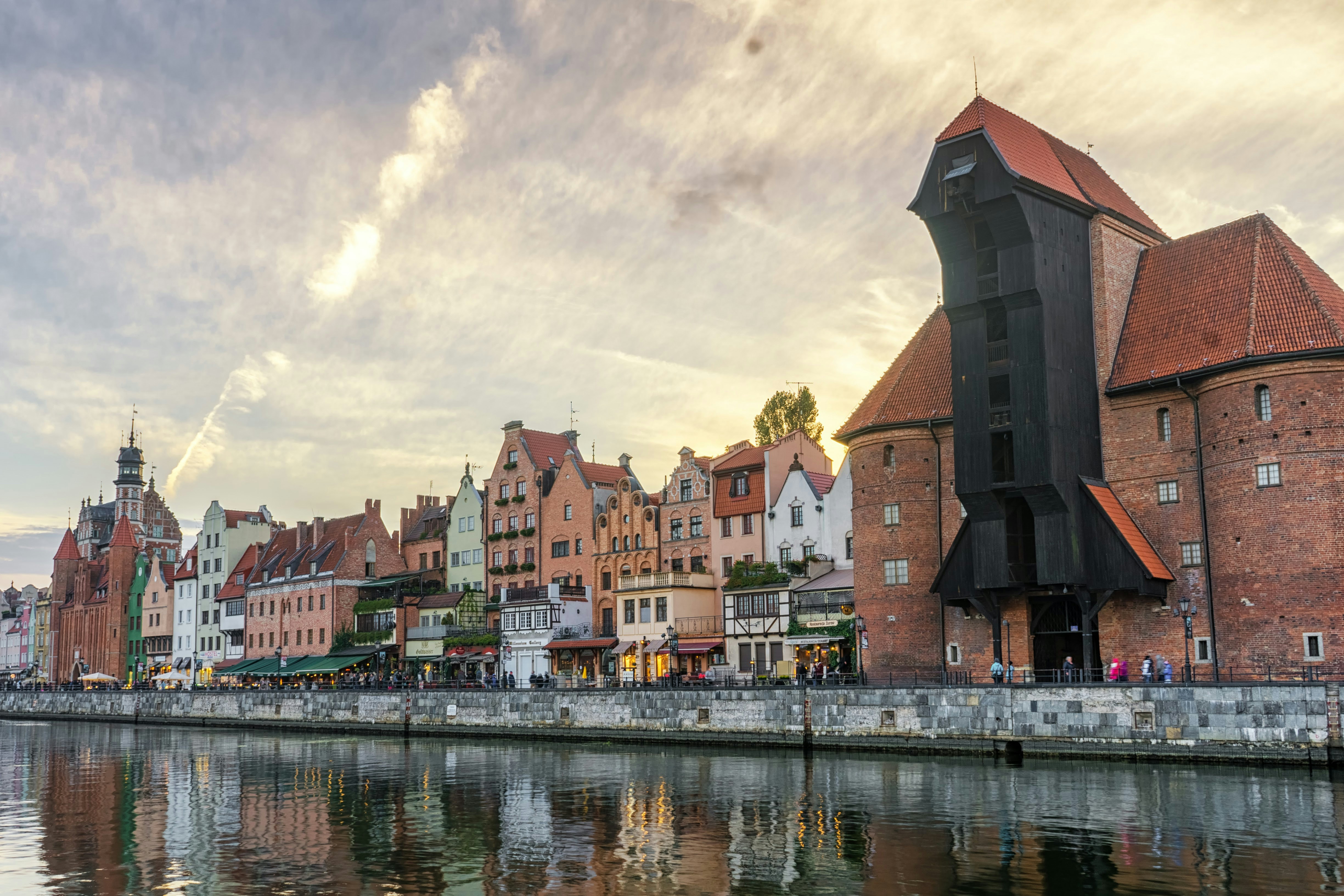 brown concrete building near body of water during daytime