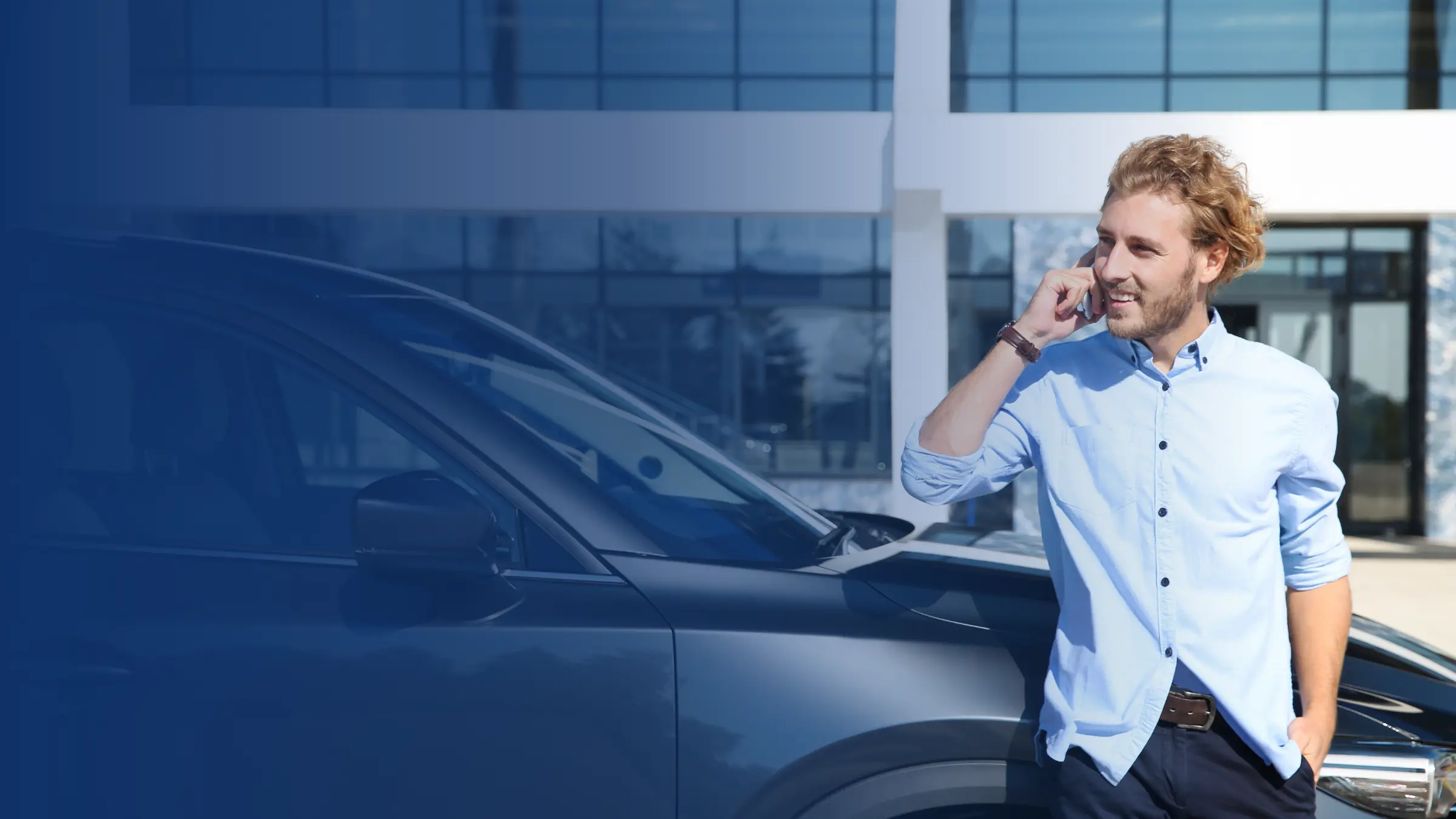 Smiling man leaning against his car while on a phone call, with a blue overlay