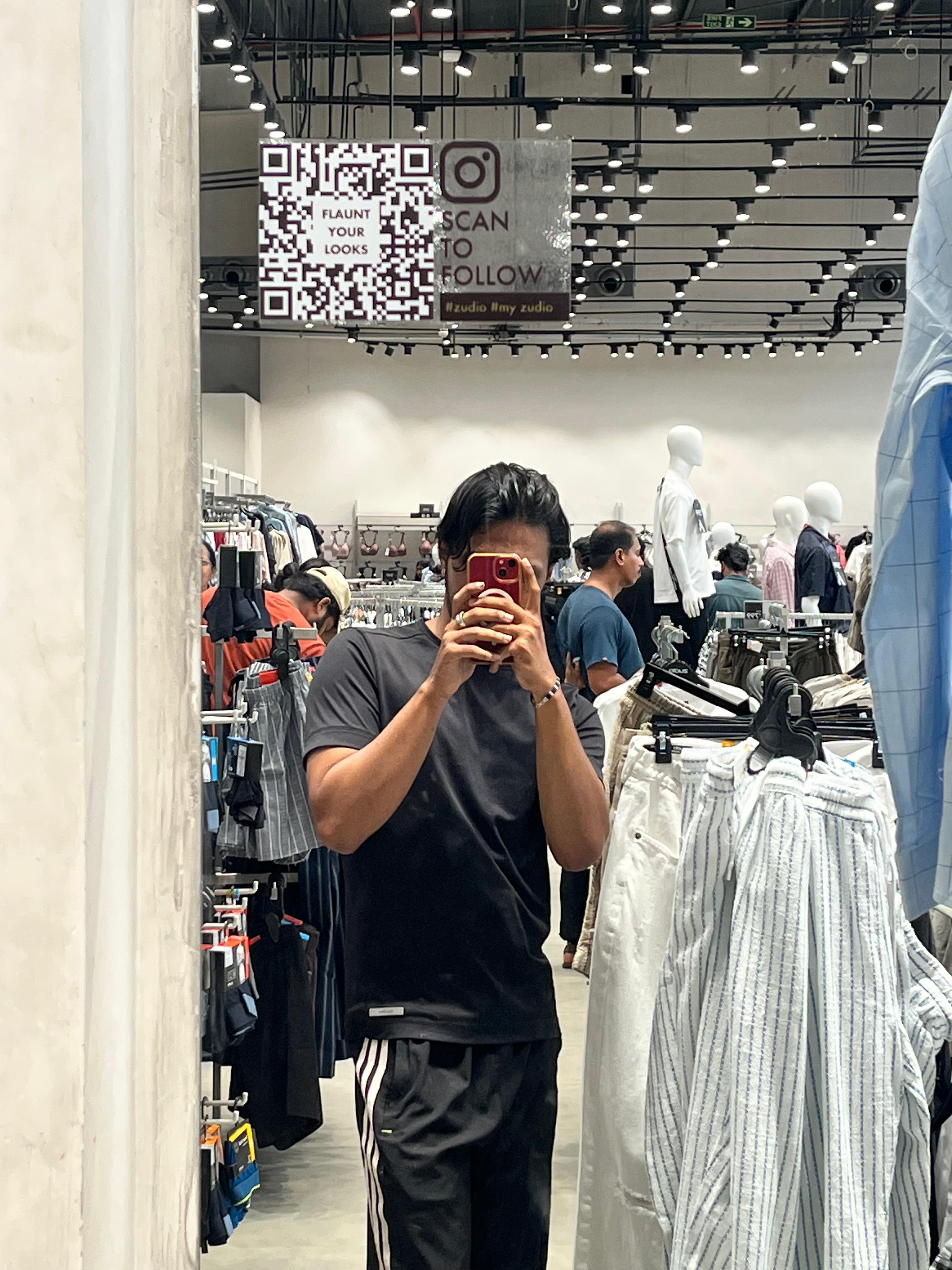 Taking a mirror photograph inside a clothing store
