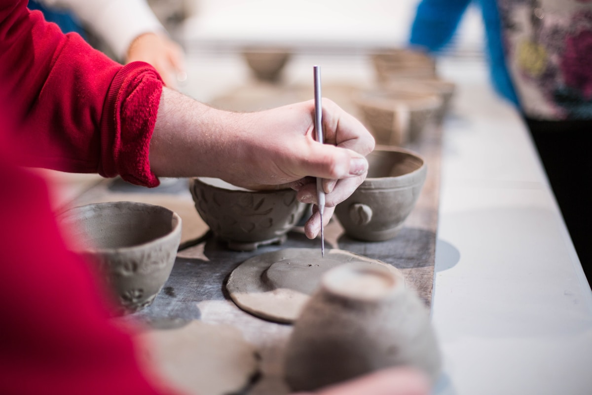 Guests participating in a pottery workshop