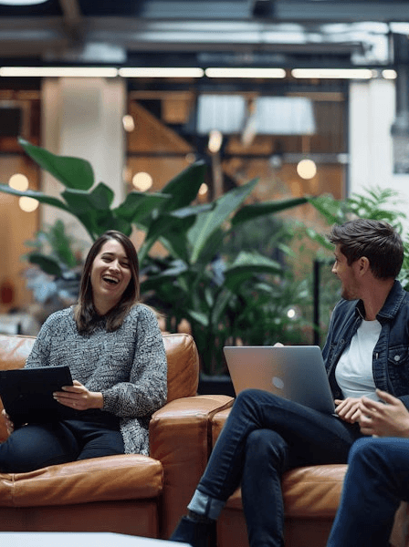 A group of four people engaged in a discussion while seated in a cozy, plant-filled setting.
