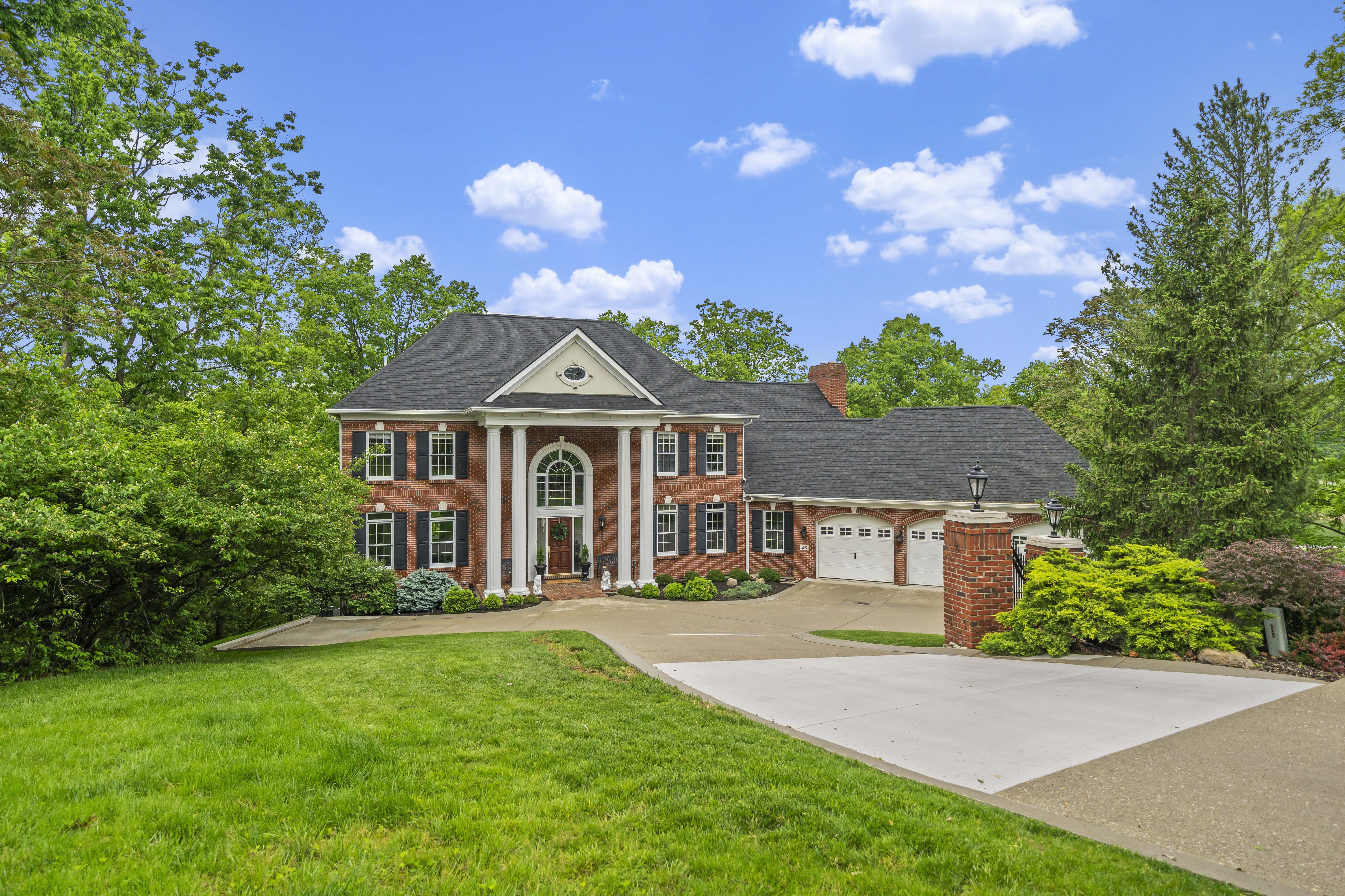 large brick home with green yard