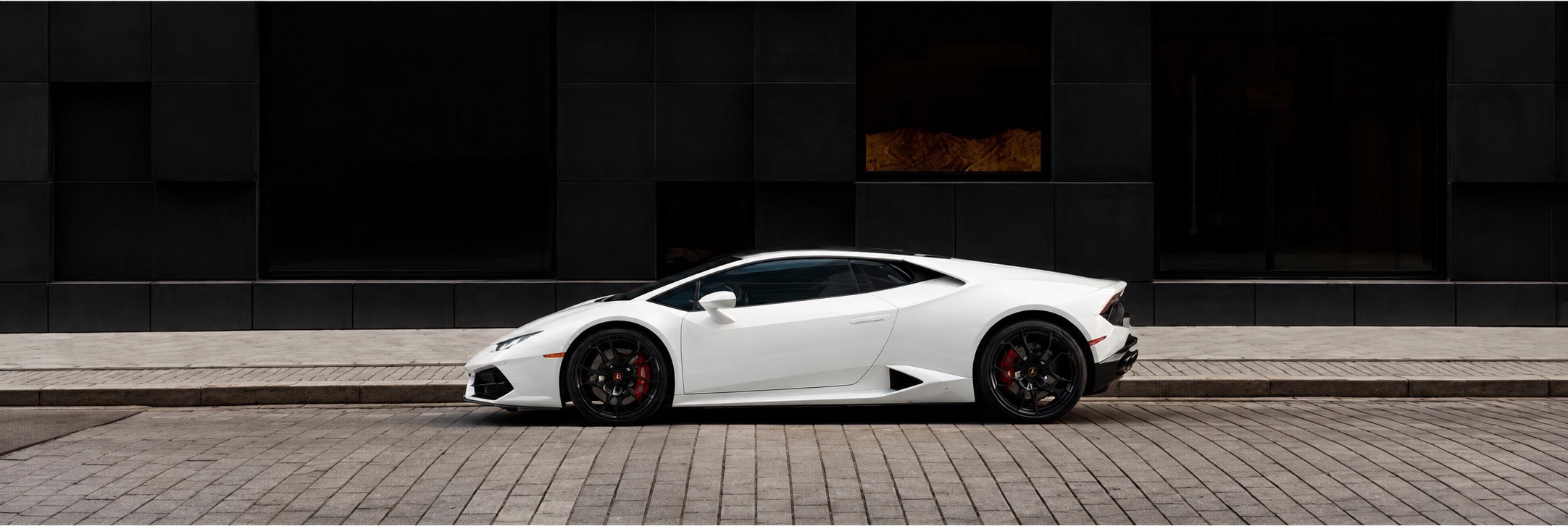 Red sports car in a garage.