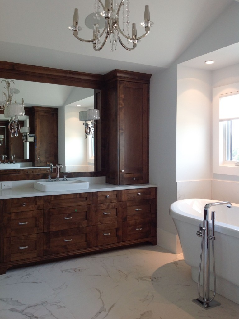 Image of Luxury primary ensuite bathroom with marble floors, freestanding tub, and custom cabinetry by KHD Homes.