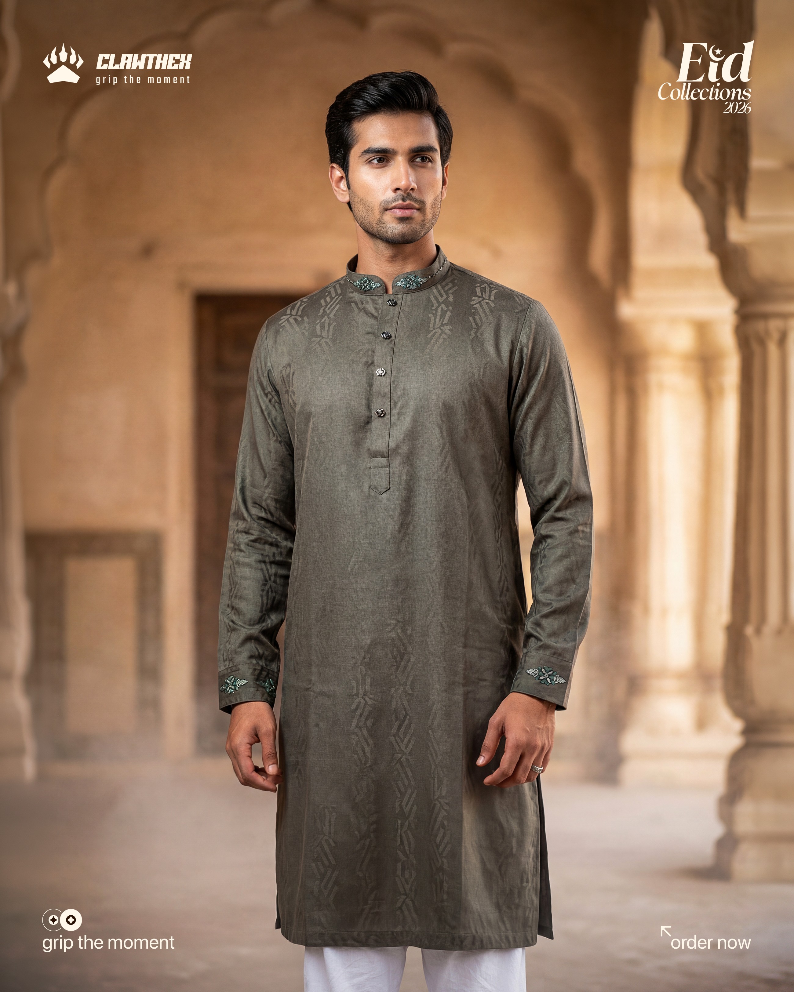 a man with a beard and glasses standing in front of a lamp