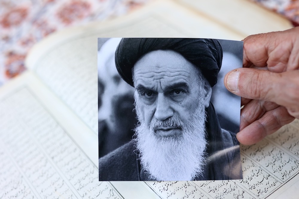 Bubjan with book and speaking to camera