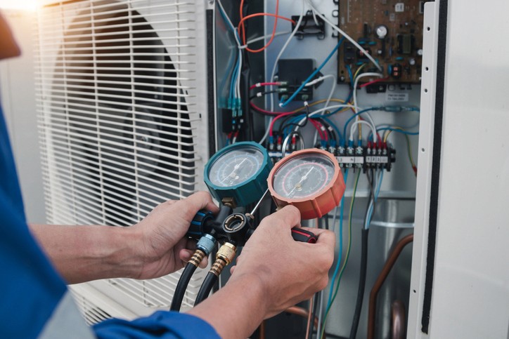 Man performing maintenance on an air purifier inside a Toronto home