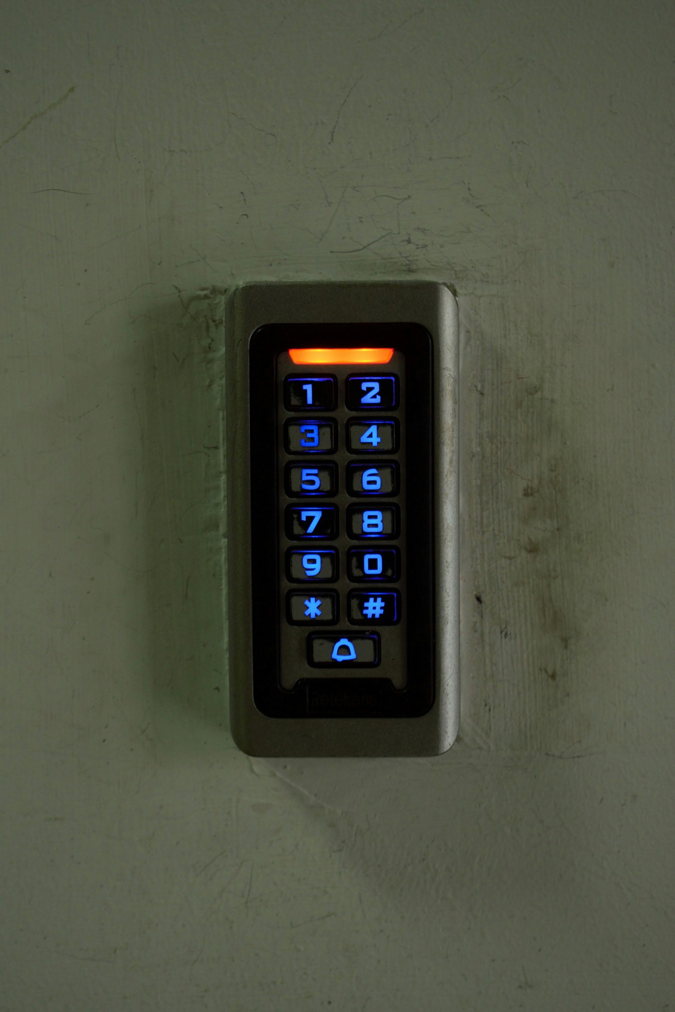 A security keypad access control system mounted on a wall.