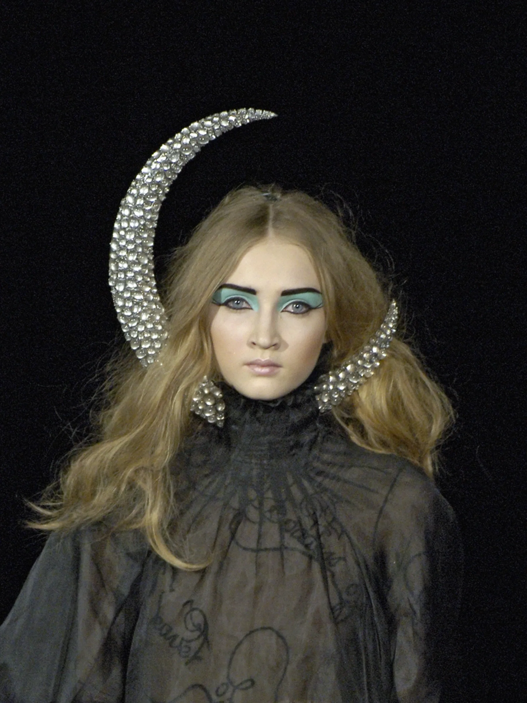 The oversized silver Moon Headpiece, an iconic piece of runway art sculpted by Shaun Leane for Alexander McQueen's 2007 collection.