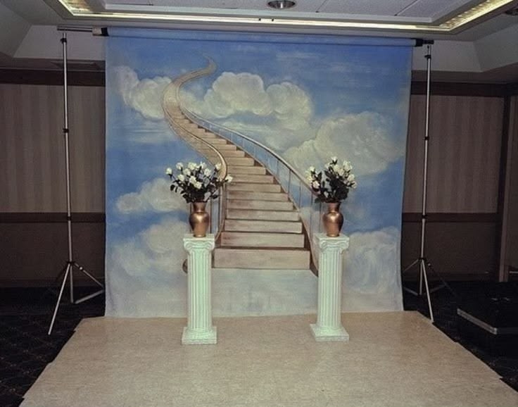 Staircase image as a studio backdrop, with two pillars, metallic vases and bunches of flowers, showing dreams and inspiration for interior design projects
