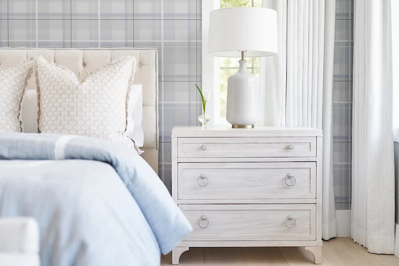 Close-up view of the primary bedroom, focusing on the nightstand and bed details in the Irvine Contemporary Coastal Remodel. Photo by Todd Huge.