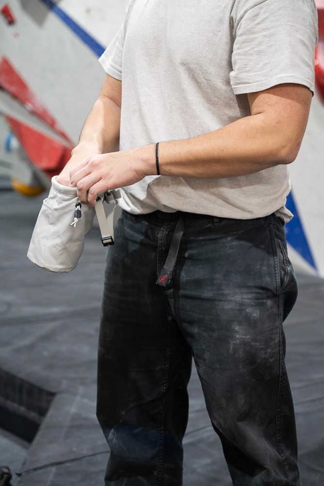 bouldering man chalking up