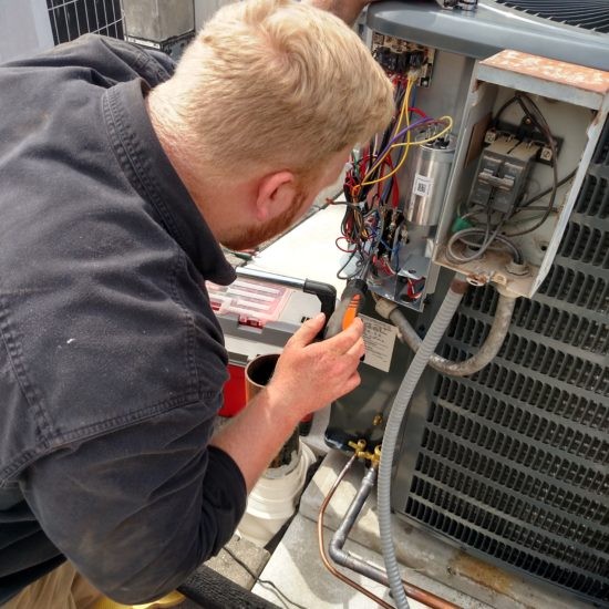 Hvac technician fixing hvac unit