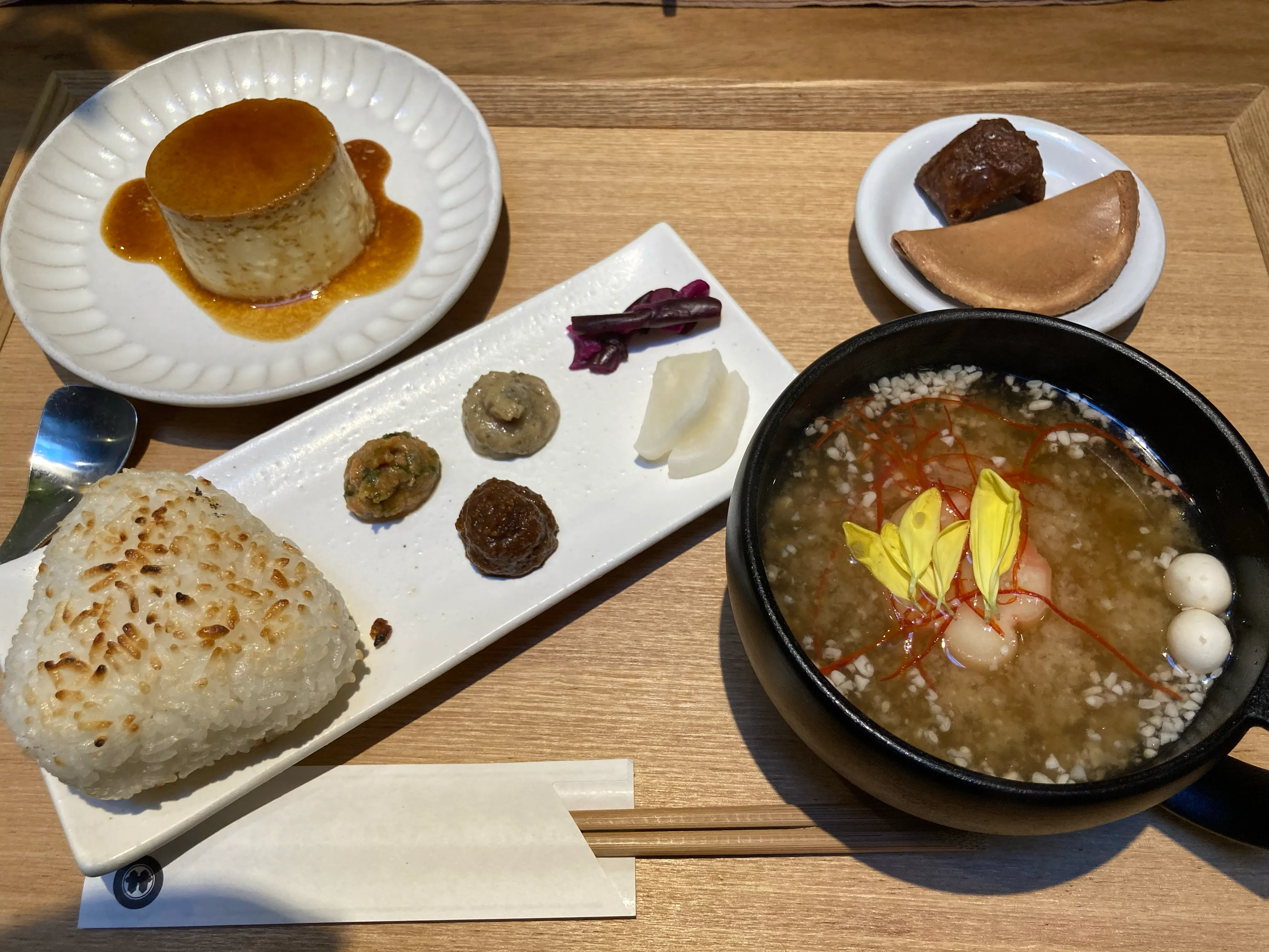 set lunch with a bowl of miso soup and onigiri and pudding