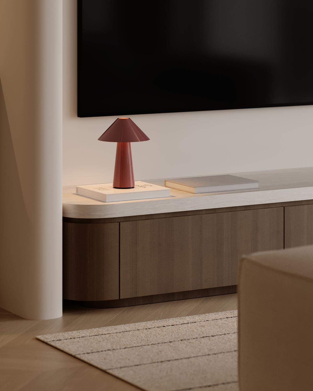 A cozy living room scene featuring a TV and a decorative mushroom lamp on a low table.