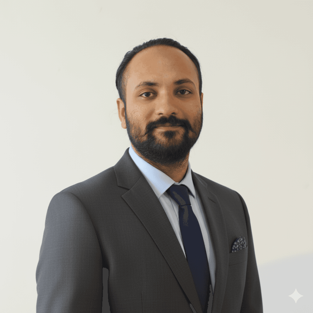 Portrait of a young man in a dark double-breasted suit and black turtleneck. Soft lighting creates a sophisticated, serious tone.