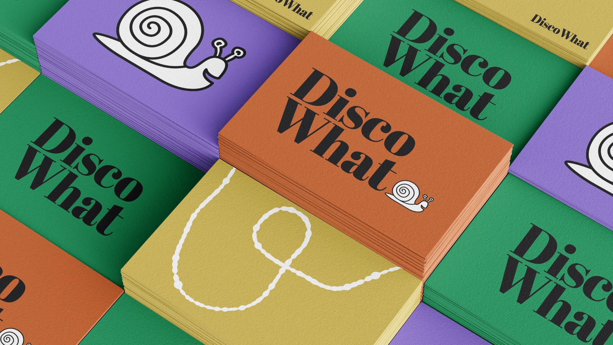 Stacks of business cards with Disco What logos printed on them.