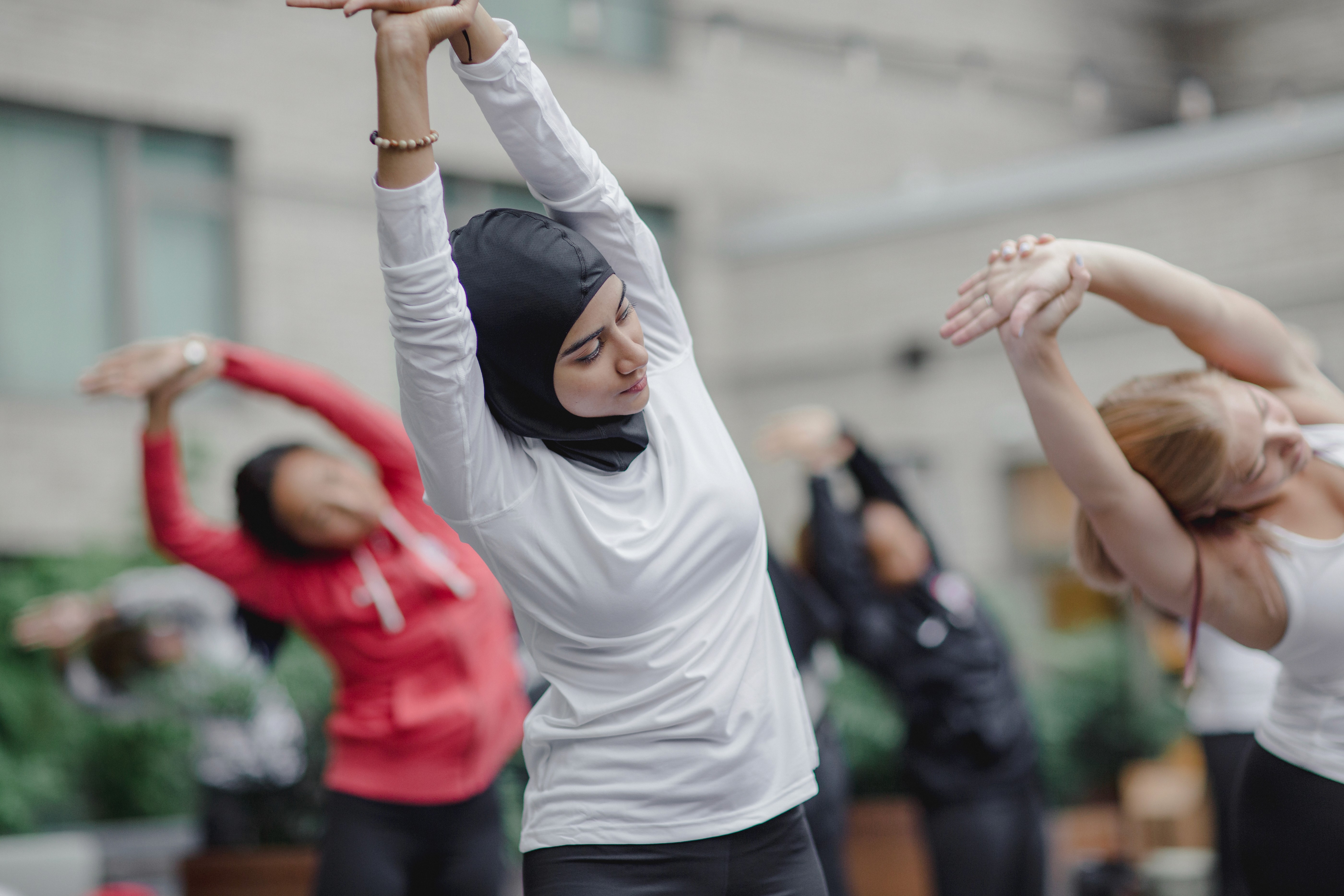 A woman in a hijab stretching and doing yoga