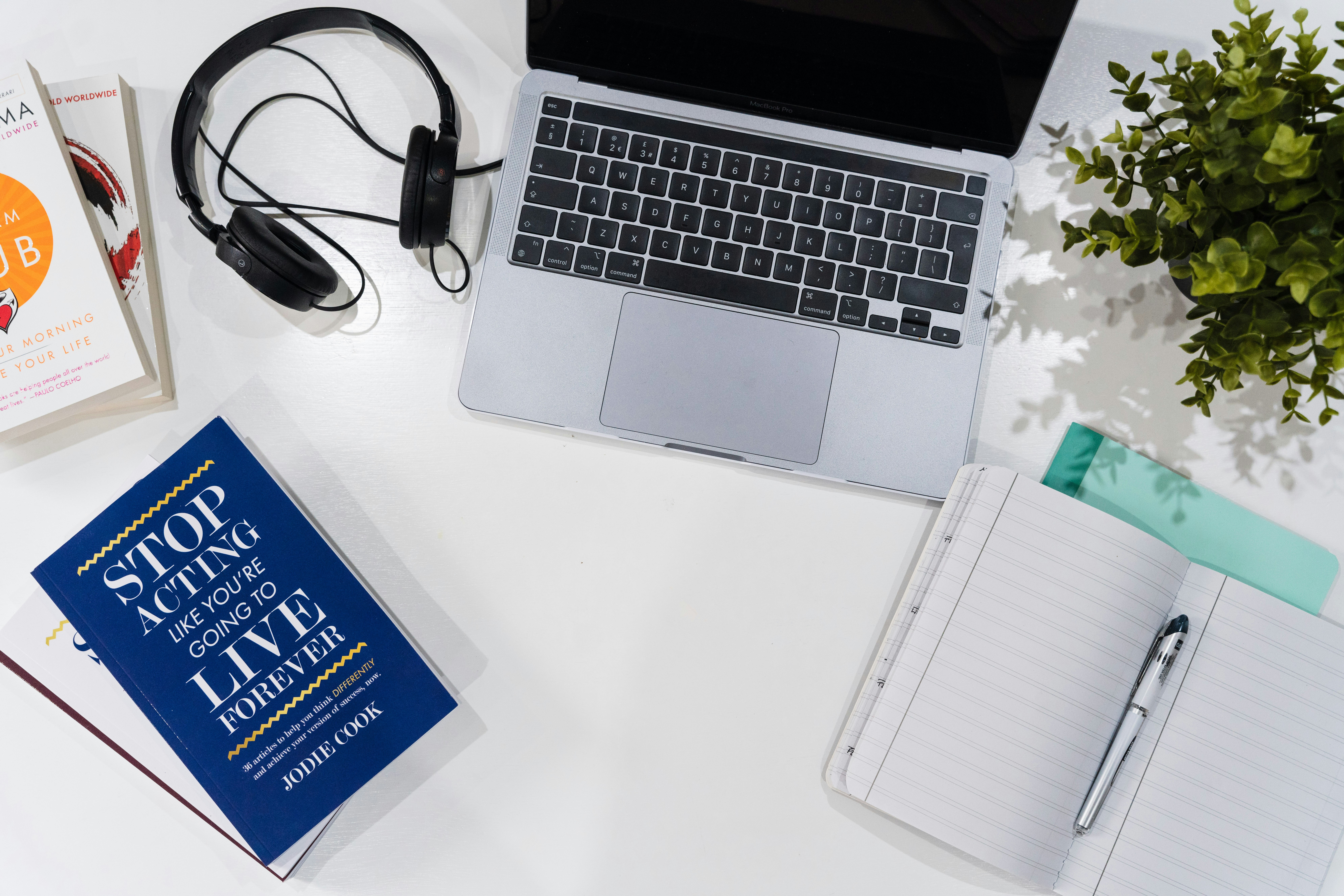 black and silver laptop computer beside black headphones