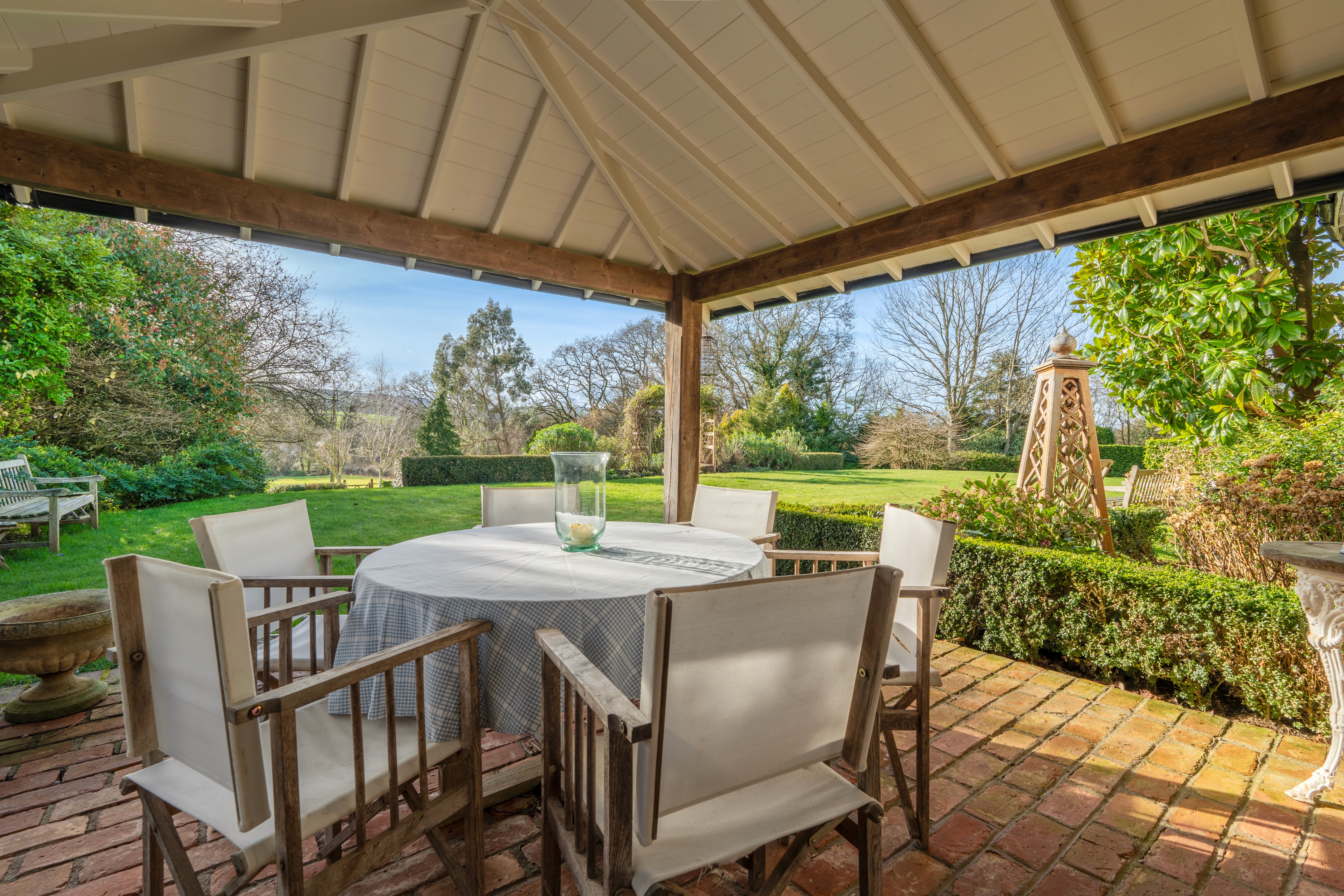 Covered terrace with outdoor seating and garden views