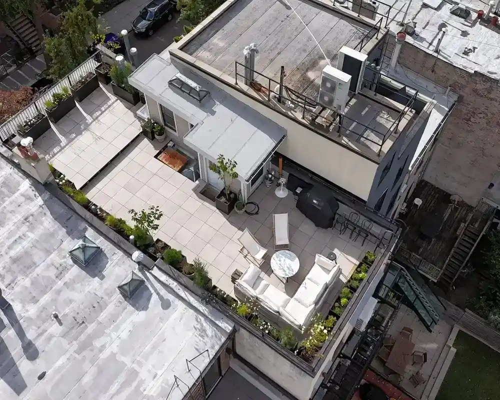 Custom TileTech Cenere-Cement pavers rooftop deck on Hybrid Pedestal base with planters, seating lounge, and grill in Park Slope, Brooklyn, NYC