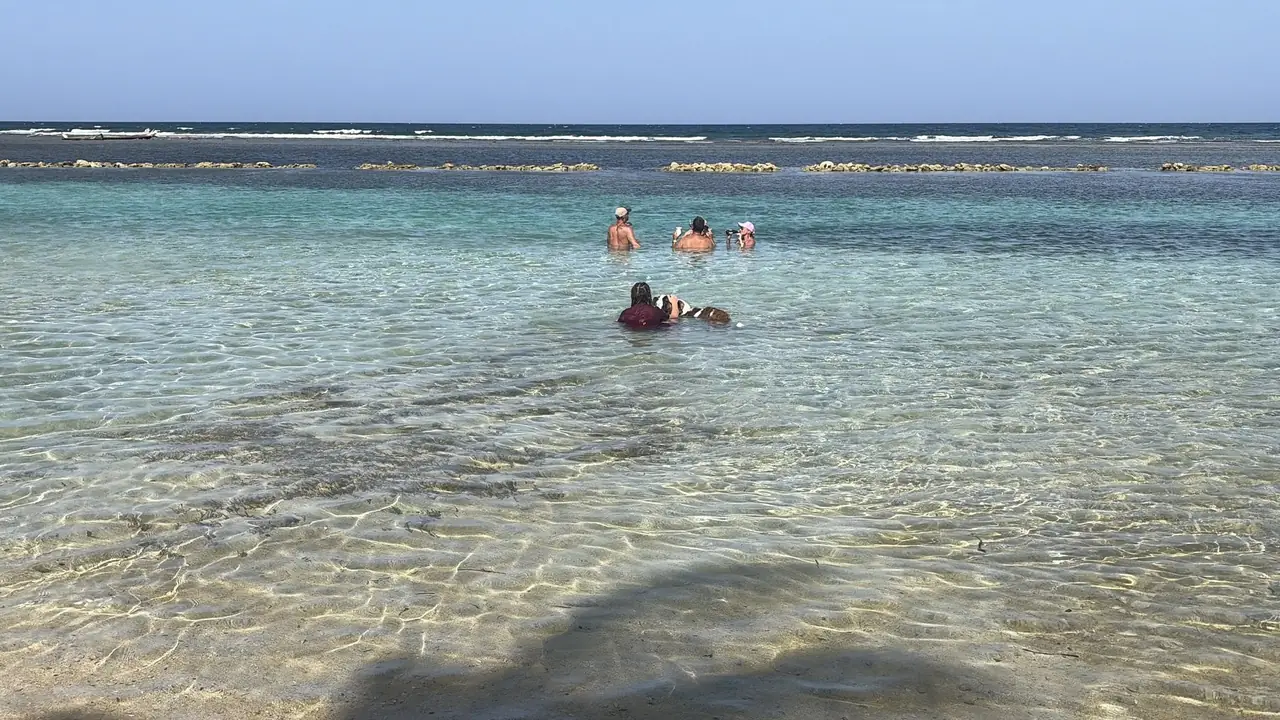 The wide shallow flat at Curación Beach Resort, where the water stays ankle deep for a long way out toward the reef.