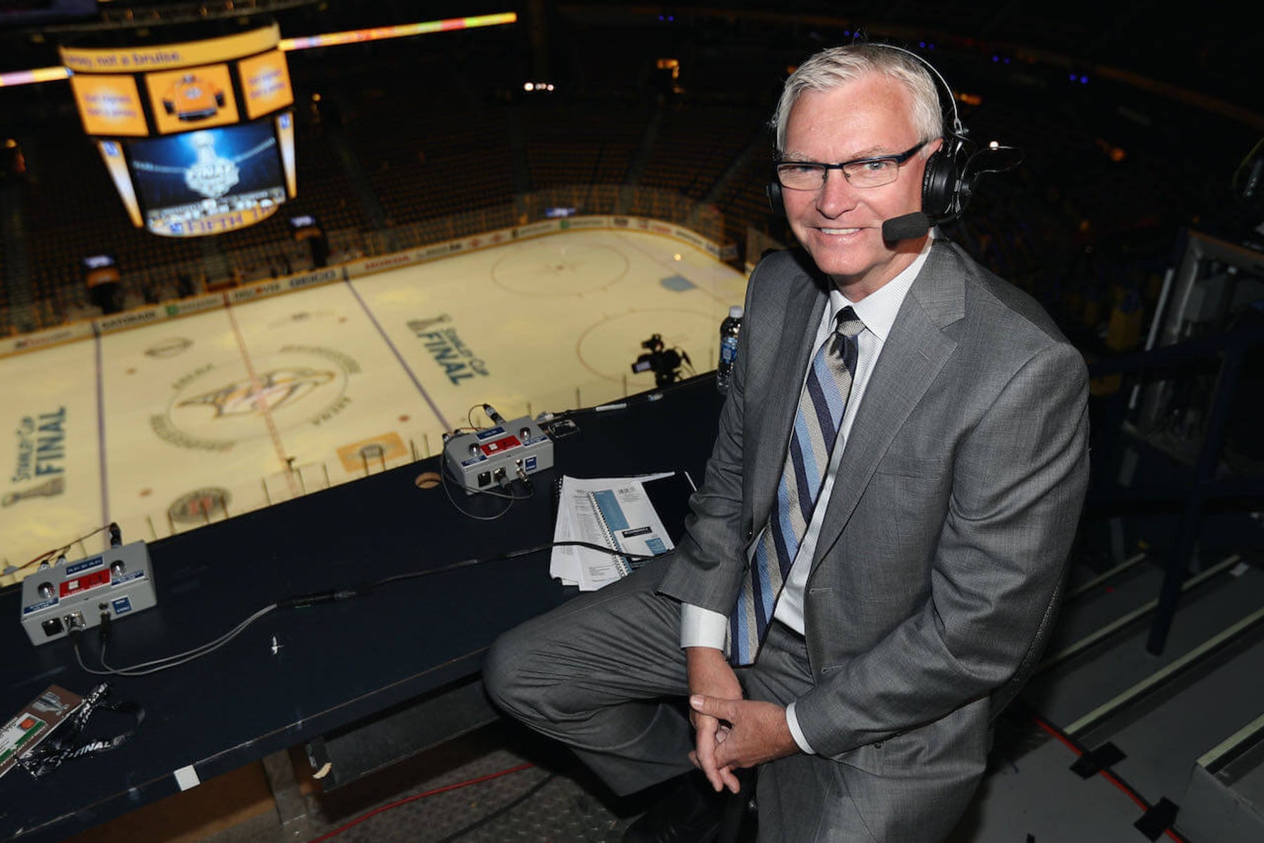 Jim Hughson, legendary hockey commentator, with a friendly smile, capturing his enthusiasm for sports broadcasting.