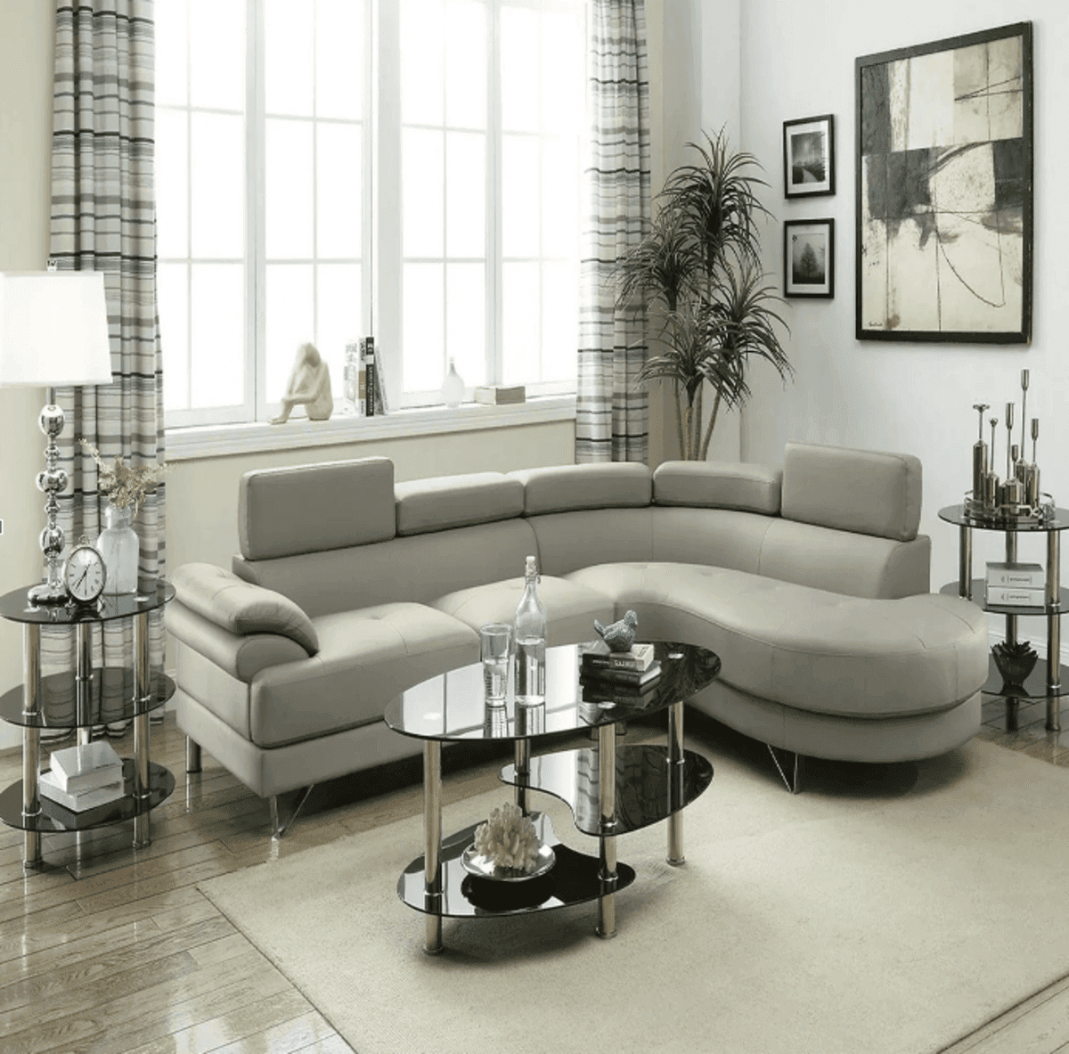 Beige Poundex faux leather sectional chaise sofa in a modern living room with glass tables and neutral decor