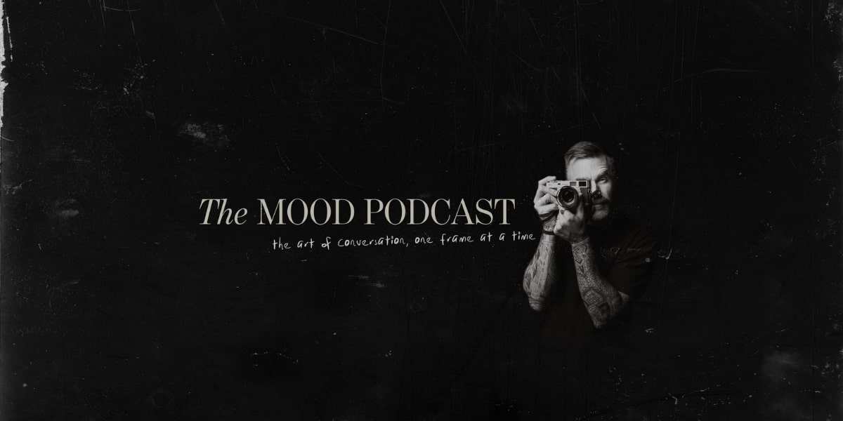Matt Jacob holding a camera, representing The MOOD Podcast's creative journey, focusing on deep, authentic conversations.