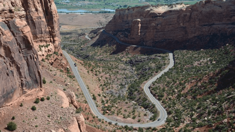 Scenic view of Colorado National Monument with red rock formations and sweeping canyon landscapes.