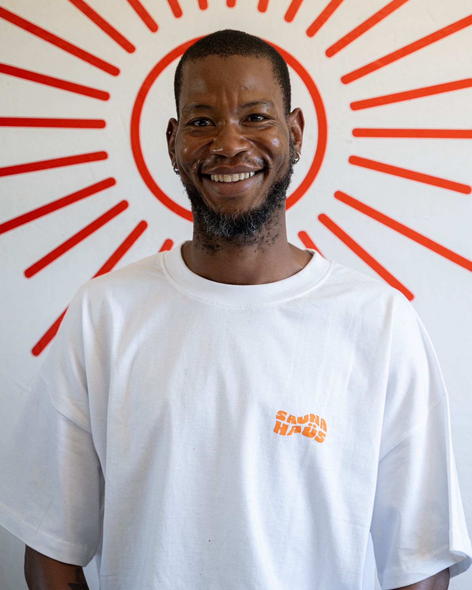 Patrick, a SaunaHaüs facilitator, smiling against a clean white background.