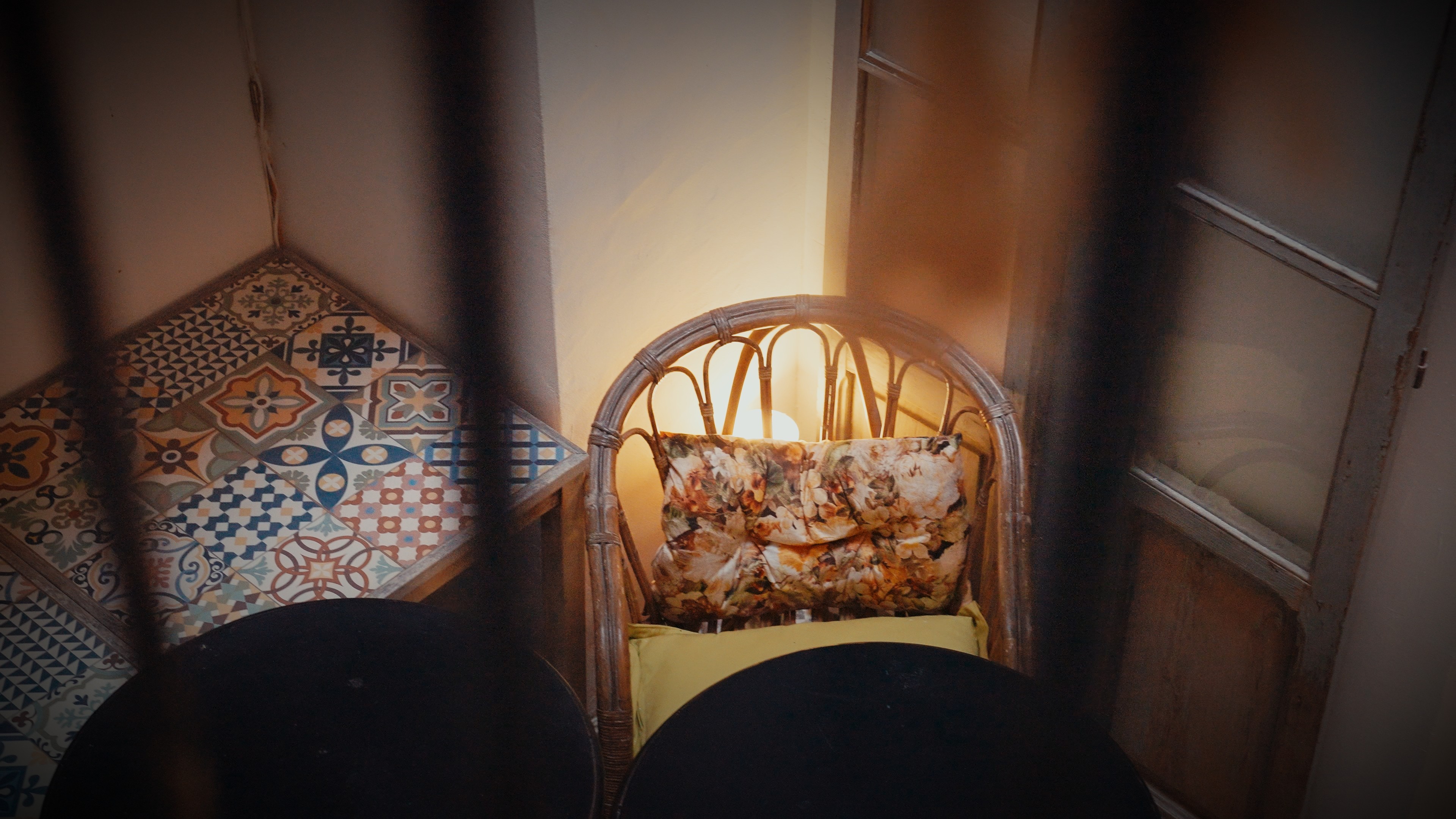 A woman wearing a shiny coat stands in focus, while a blurred background creates a sense of movement.